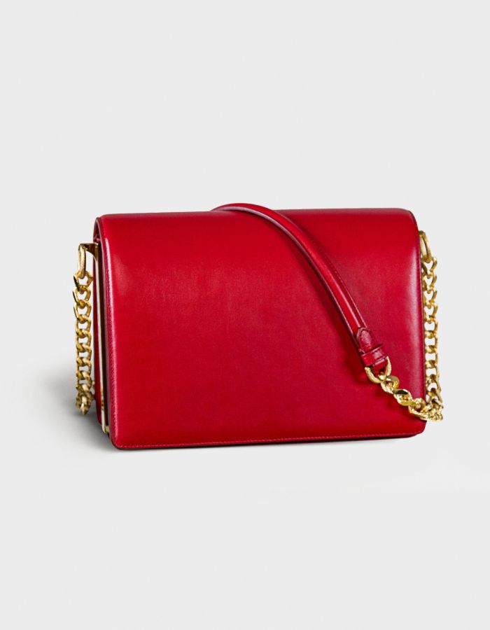 Elegant red leather handbag with gold chain strap.