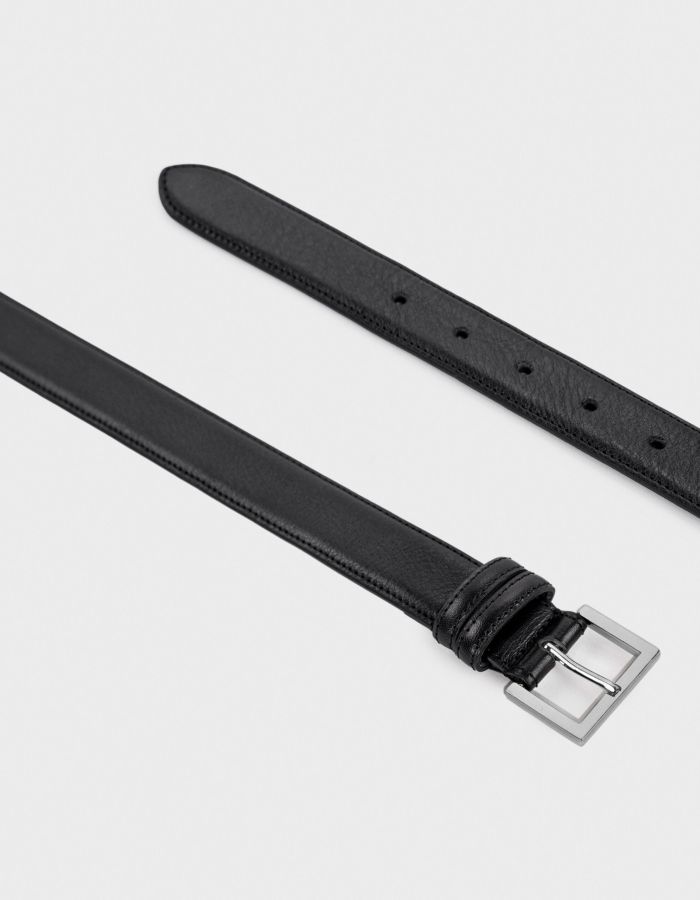 Black leather belt with a silver rectangular buckle.
