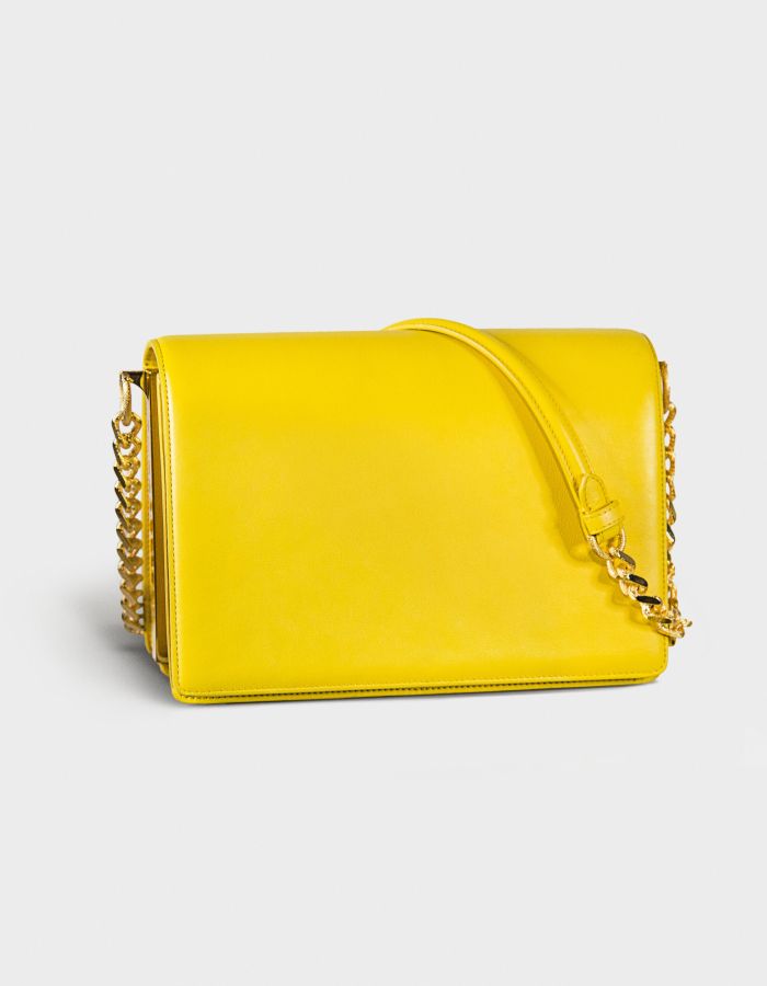 Bright yellow handbag with a gold chain strap.