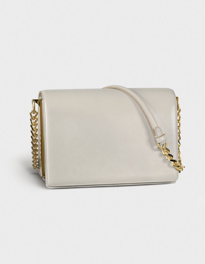 Elegant white handbag with gold chain detail.